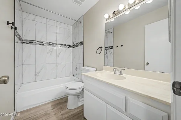 a bathroom with a sink toilet tub and shower