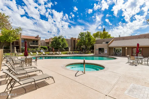 a swimming pool with outdoor seating and yard