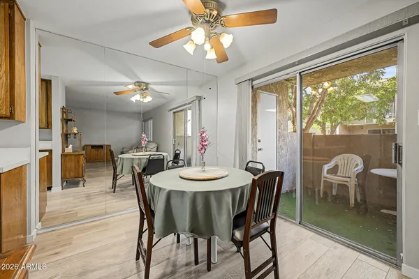 a dining room with furniture a chandelier and wooden floor