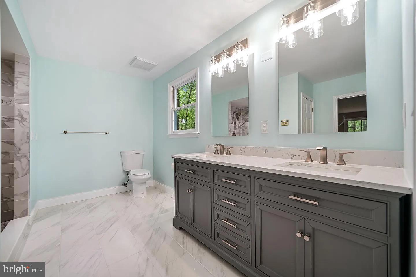 11 Oak Lane Malvern, PA 19355 - Photo 22 of 34 a spacious bathroom with a double vanity sink toilet and a mirror