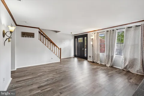 a view of an entryway with wooden floor