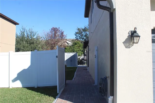 a kitchen with stainless steel appliances granite countertop a refrigerator a sink dishwasher a microwave oven and a dining table with wooden floor