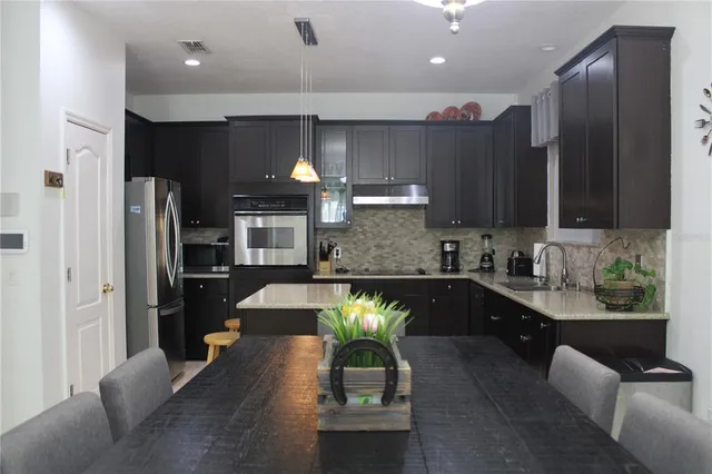 a kitchen with a sink a refrigerator and a stove