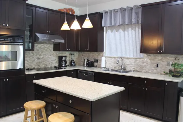 a living room with furniture a dining table and paintings on the wall