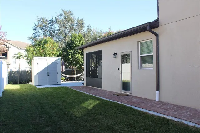 a view of a house with backyard and sitting area