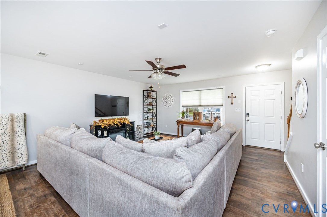 2077 Forest Circle Aylett, VA 23009 - Photo 20 of 36 a living room with furniture a flat screen tv and a table
