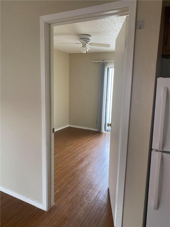 3115 Helms Street, Unit 209 Austin, TX 78705 - Photo 17 of 33 an empty room with wooden floor and a hallway