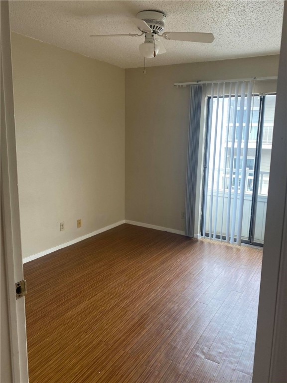 3115 Helms Street, Unit 209 Austin, TX 78705 - Photo 18 of 33 an empty room with wooden floor and windows