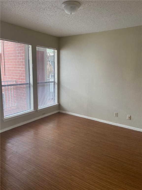3115 Helms Street, Unit 209 Austin, TX 78705 - Photo 4 of 33 a view of an empty room with wooden floor and a window