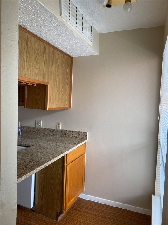 3115 Helms Street, Unit 209 Austin, TX 78705 - Photo 7 of 33 a room with wooden floor and mirror