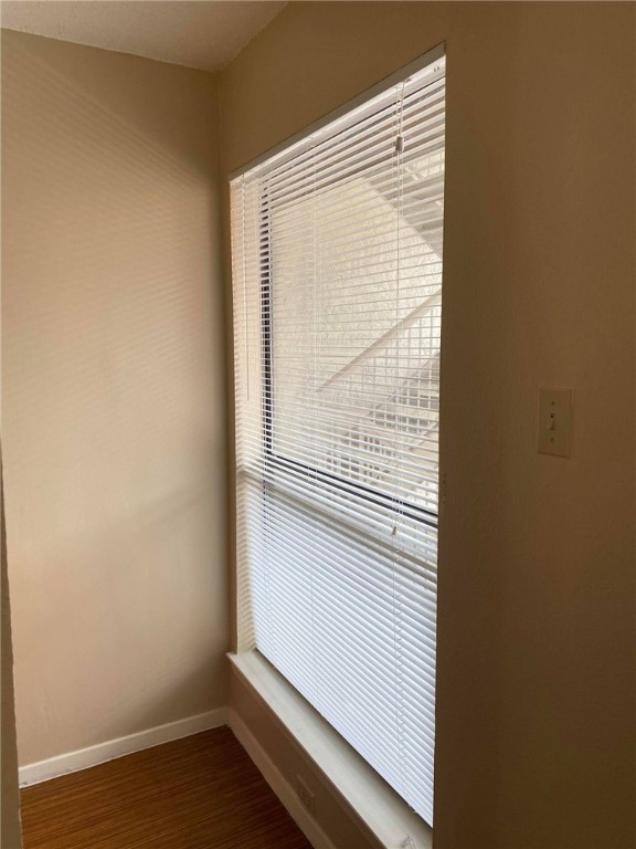 3115 Helms Street, Unit 209 Austin, TX 78705 - Photo 8 of 33 a view of a small space with wooden floor and a window