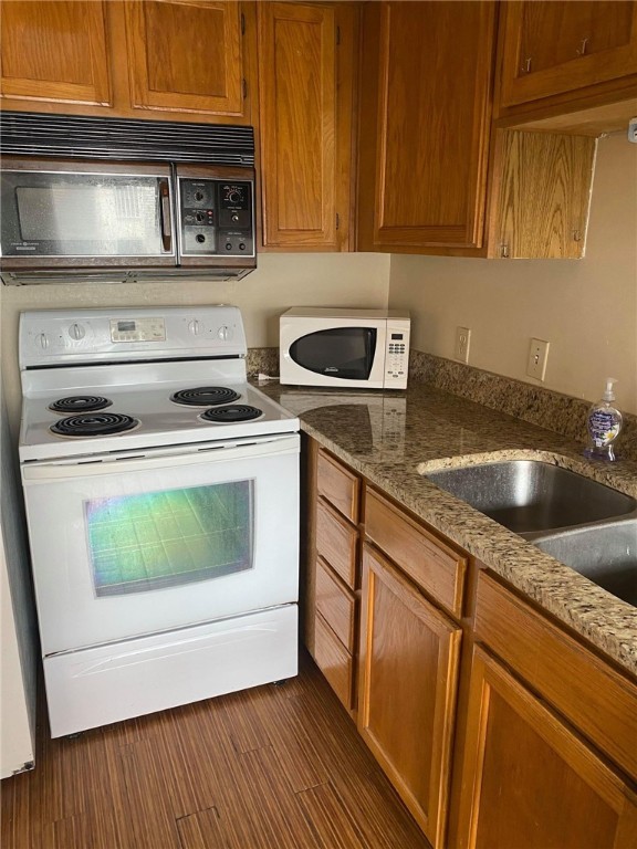 3115 Helms Street, Unit 209 Austin, TX 78705 - Photo 10 of 33 a kitchen with granite countertop a sink a stove and cabinets