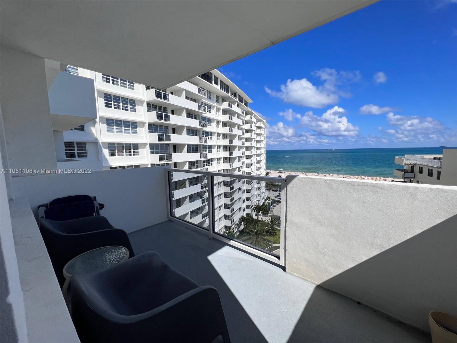 100 Lincoln Road, Unit 1121 Miami Beach, FL 33139 - Photo 1 of 22 a balcony with table and chairs