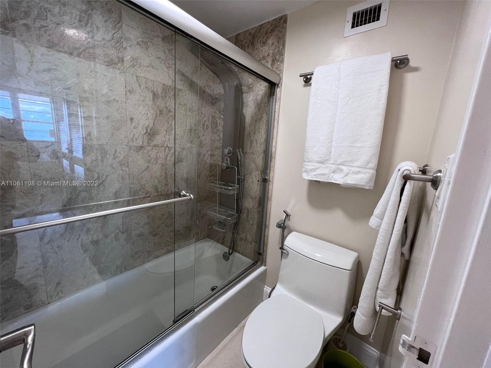 100 Lincoln Road, Unit 1121 Miami Beach, FL 33139 - Photo 13 of 22 a bathroom with a tub and a shower