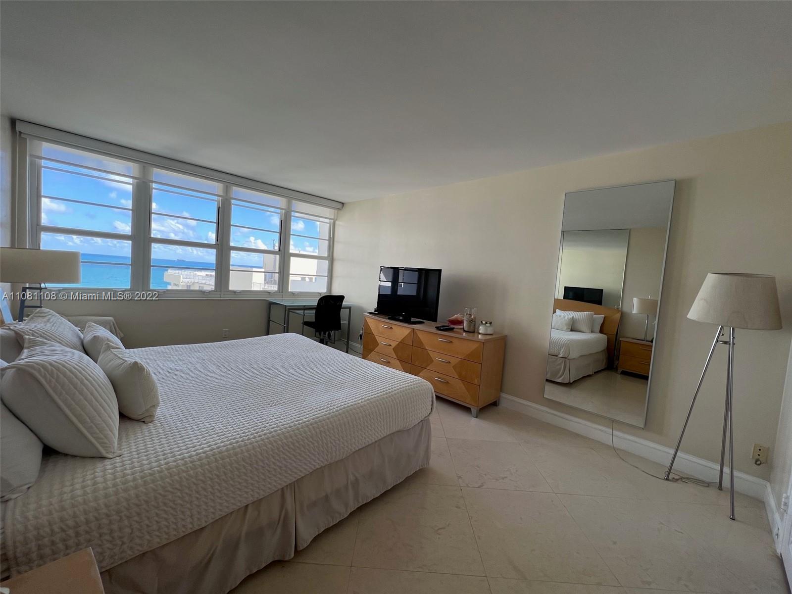 100 Lincoln Road, Unit 1121 Miami Beach, FL 33139 - Photo 16 of 22 a bedroom with a bed and large windows