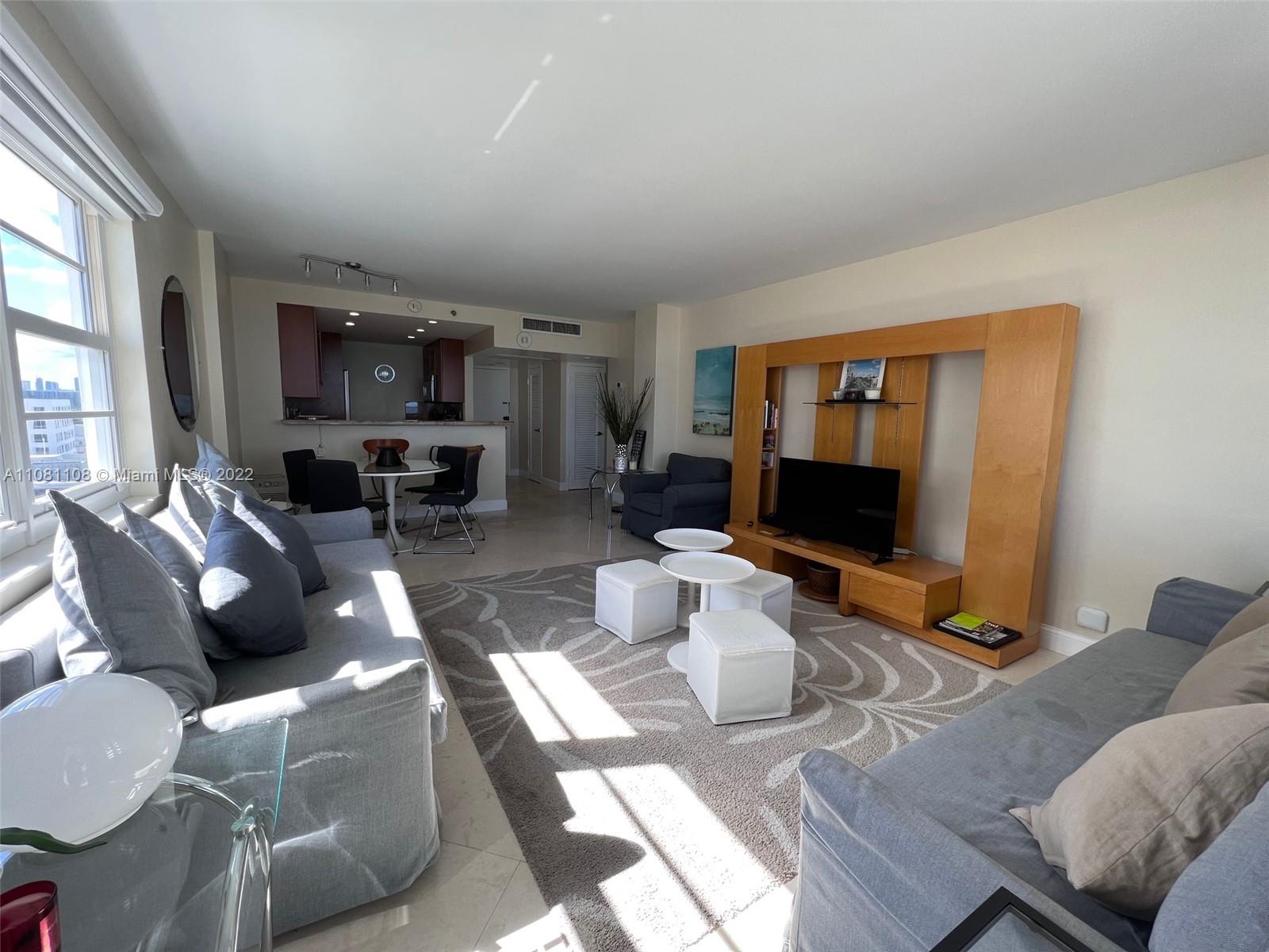 100 Lincoln Road, Unit 1121 Miami Beach, FL 33139 - Photo 6 of 22 a living room with furniture a flat screen tv and kitchen view
