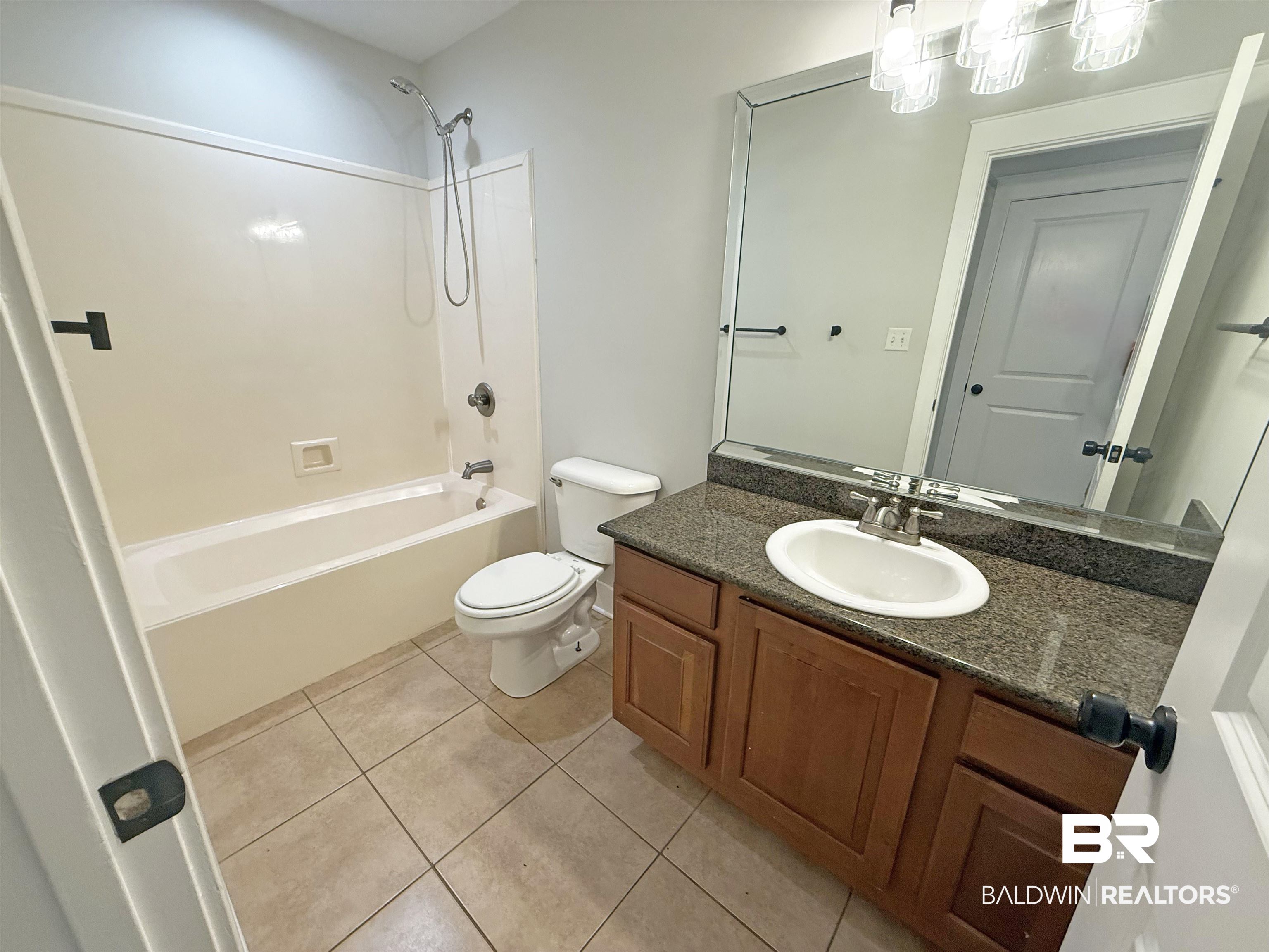 22023 Garland Loop Silverhill, AL 36576 - Photo 24 of 33 Full bathroom featuring vanity, bathtub / shower combination, and tile patterned floors