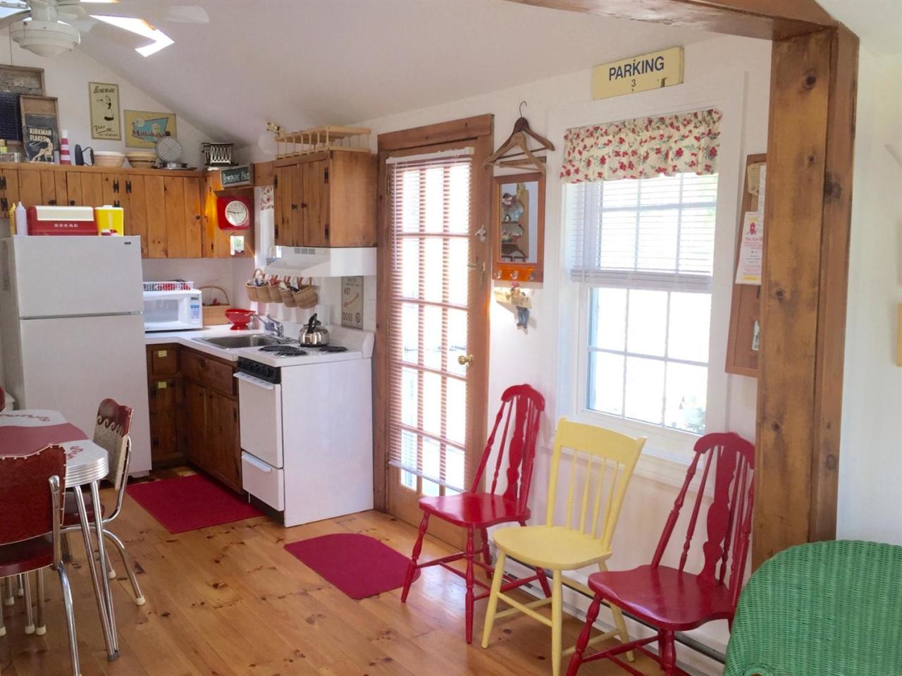 54 Hay Road, Unit 3 Eastham, MA 02642 - Photo 5 of 30 a view of a dining room with furniture window and outside view