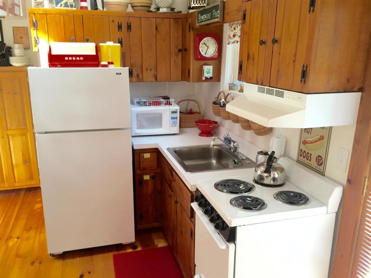 54 Hay Road, Unit 3 Eastham, MA 02642 - Photo 6 of 30 a kitchen with a refrigerator and a stove
