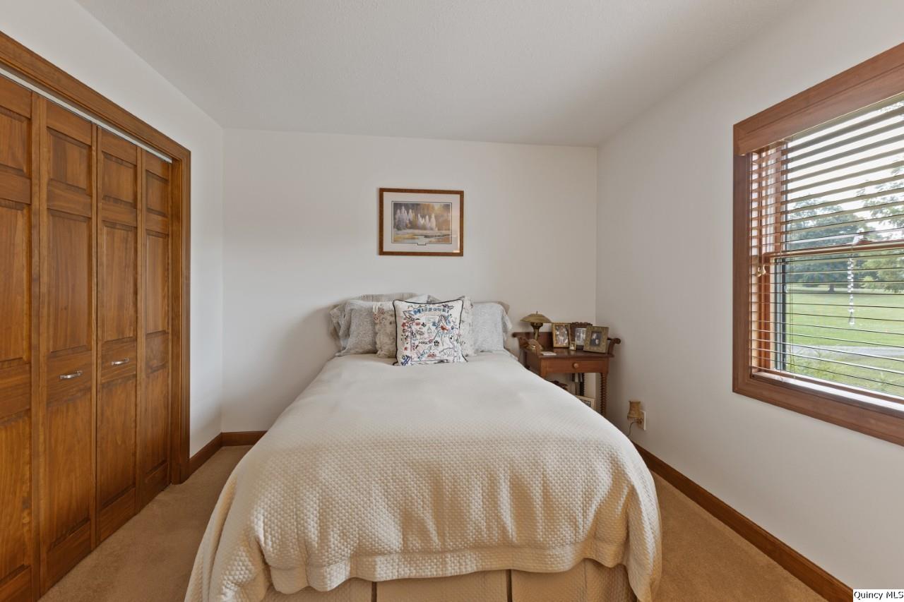 8508 Centerville Road Hannibal, MO 63401 - Photo 14 of 36 a bedroom with a bed and a window