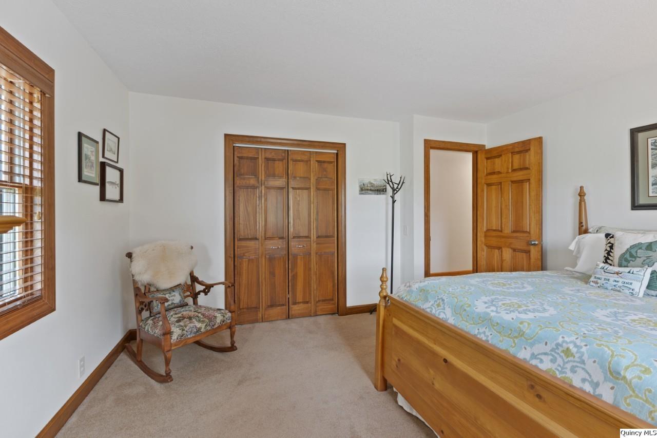 8508 Centerville Road Hannibal, MO 63401 - Photo 16 of 36 a bedroom with a bed and large windows