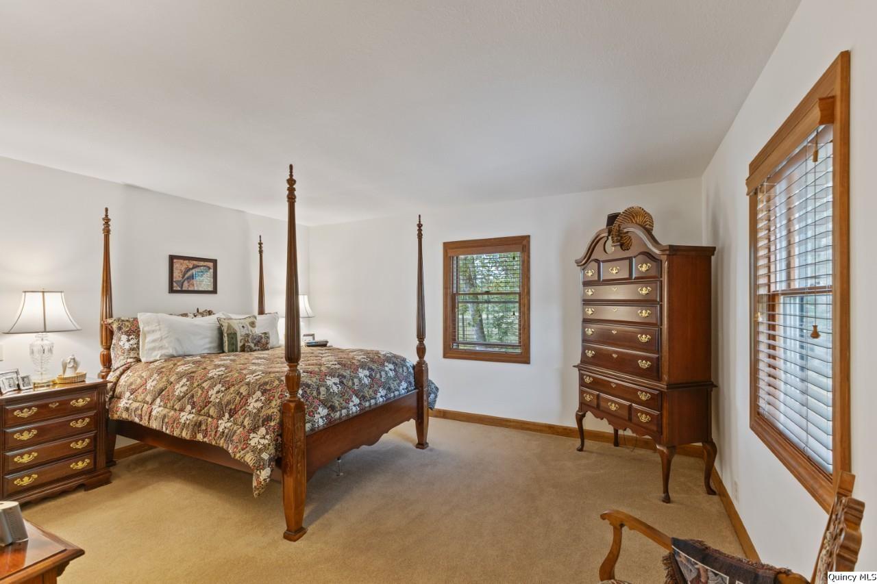 8508 Centerville Road Hannibal, MO 63401 - Photo 18 of 36 a bedroom with a bed next to a window and a flat tv screen