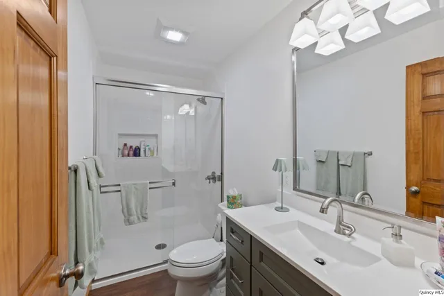 a bathroom with a sink toilet and shower