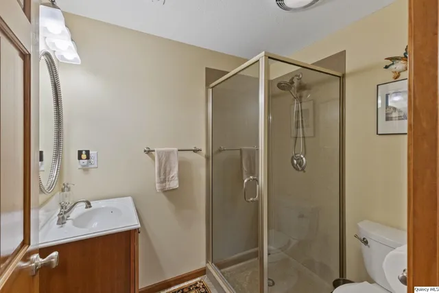 a bathroom with a shower sink and mirror