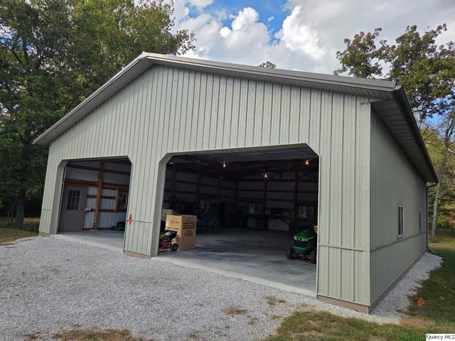 a view of a house with a garage and a chair