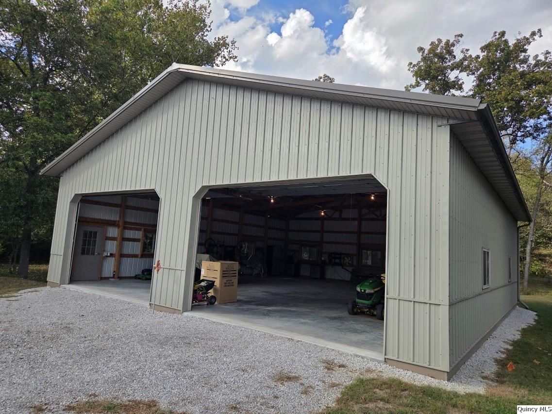 8508 Centerville Road Hannibal, MO 63401 - Photo 32 of 36 a view of a house with a garage and a chair