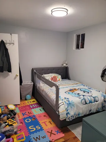 a bedroom with a bed and a dresser in it