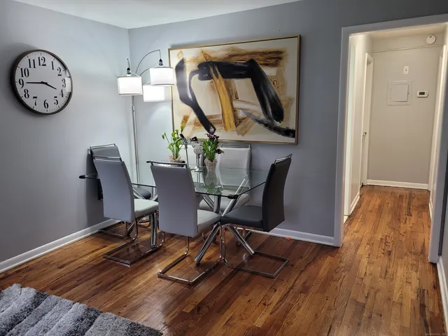 a view of a workspace with furniture and wooden floor