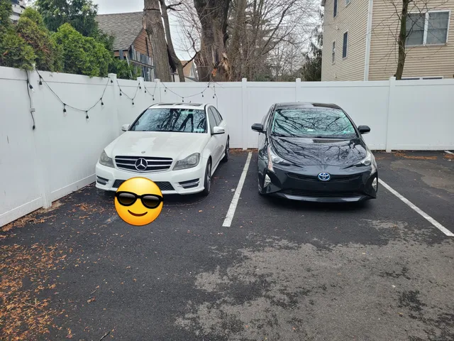 a view of a small car is parked in the road