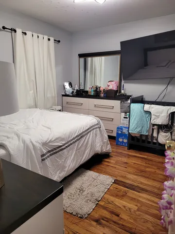 a bedroom with a bed and a mirror