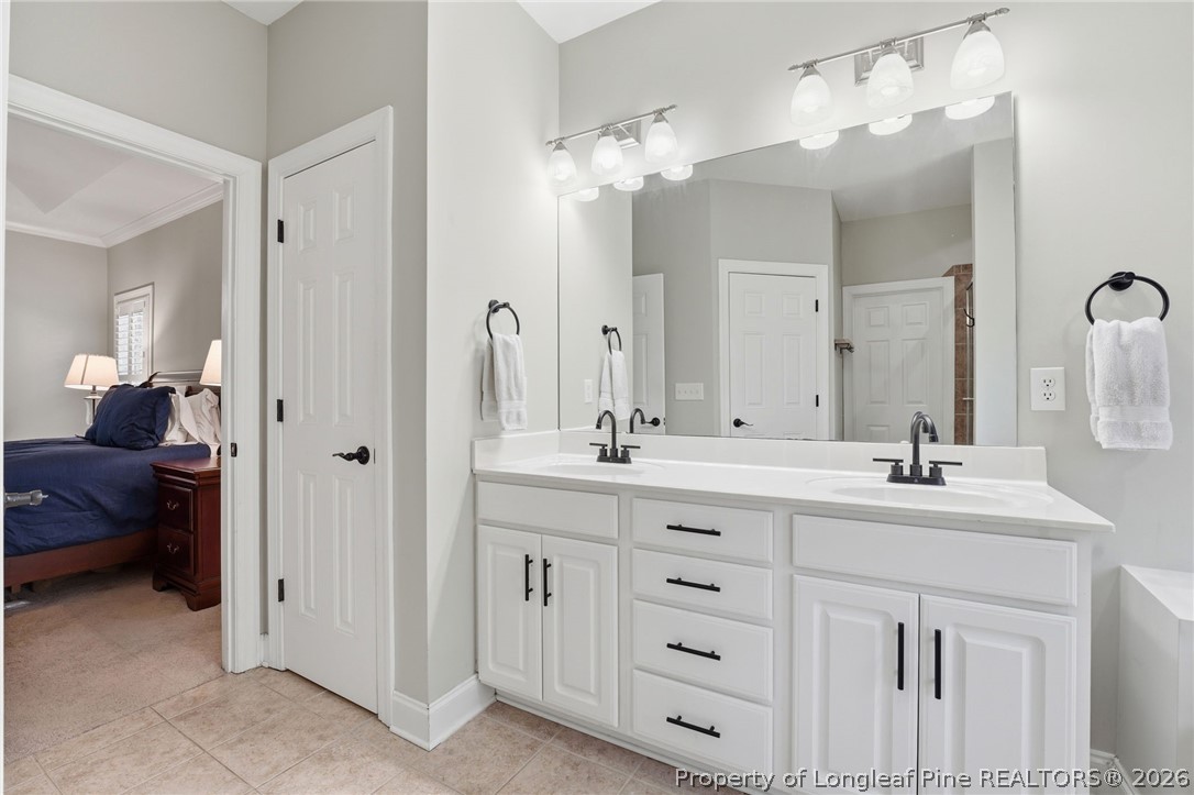16 Ridge Road Jackson Springs, NC 27281 - Photo 27 of 50 a bathroom with double vanity sinks a vanity a lamp and a mirror