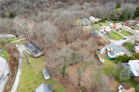 a aerial view of a house with a yard