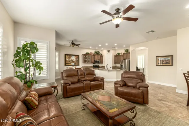 a living room with furniture ceiling fan and a rug