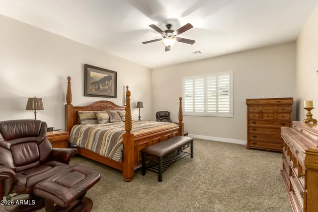 a spacious bedroom with a bed and a couch