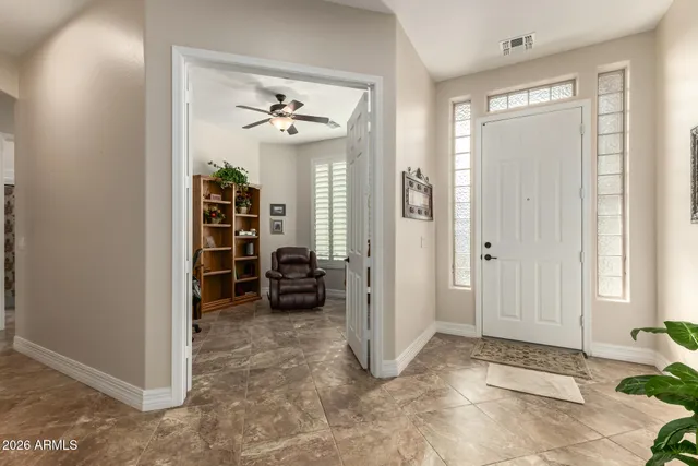 a view of a livingroom with a chandelier and closet