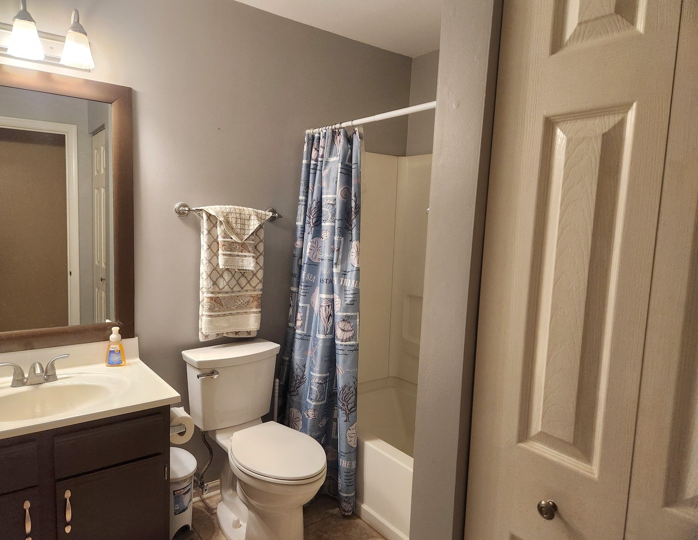 1013 Saxon Court, Unit B Elgin, IL 60120 - Photo 12 of 17 a white toilet sitting next to a bathroom sink