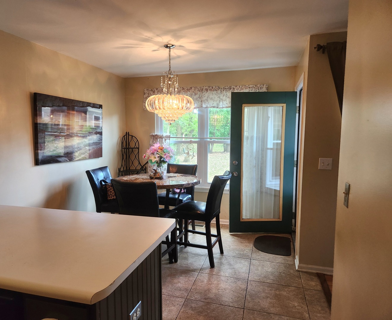 1013 Saxon Court, Unit B Elgin, IL 60120 - Photo 7 of 17 a view of a dining room with furniture and chandelier