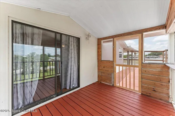 a view of a balcony with wooden floor