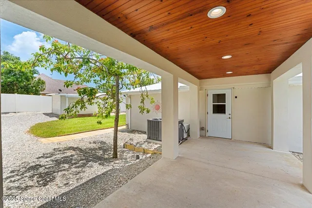 a view of a room with a ceiling fan and a window