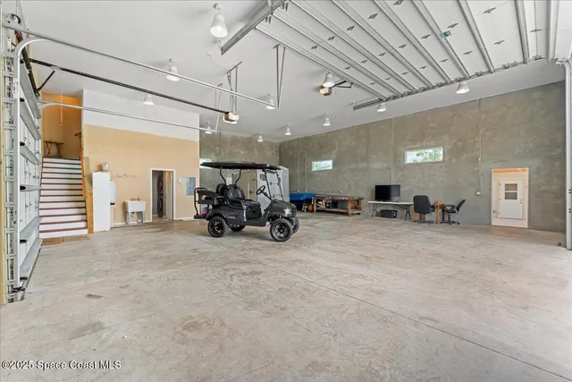 a living room with furniture and a dining table with kitchen view