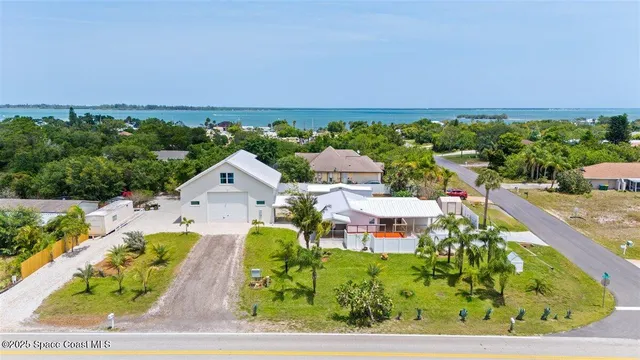 an aerial view of a house with a yard basket ball court and outdoor seating