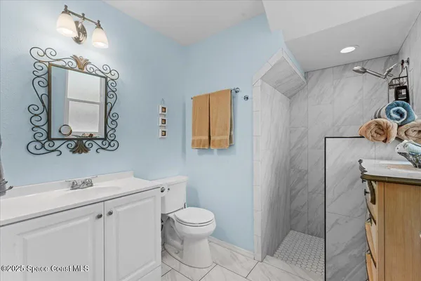 a white toilet sitting next to a bathroom sink