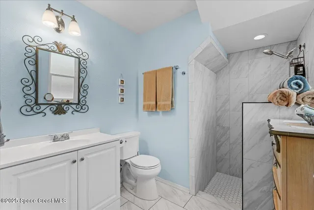 a white toilet sitting next to a bathroom sink