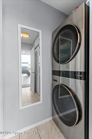 a kitchen with stainless steel appliances granite countertop a table chairs in it and a large window