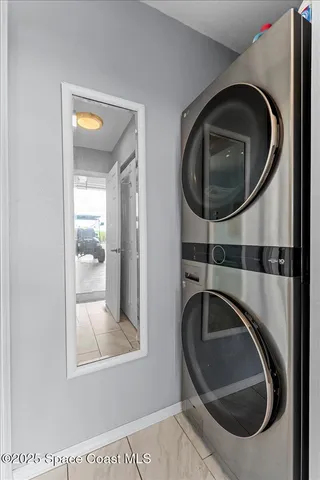 a kitchen with stainless steel appliances granite countertop a table chairs in it and a large window