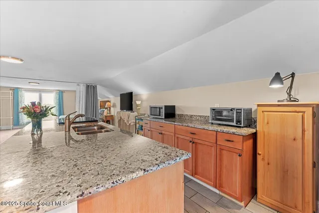 a kitchen with stainless steel appliances granite countertop a sink and a granite counter tops